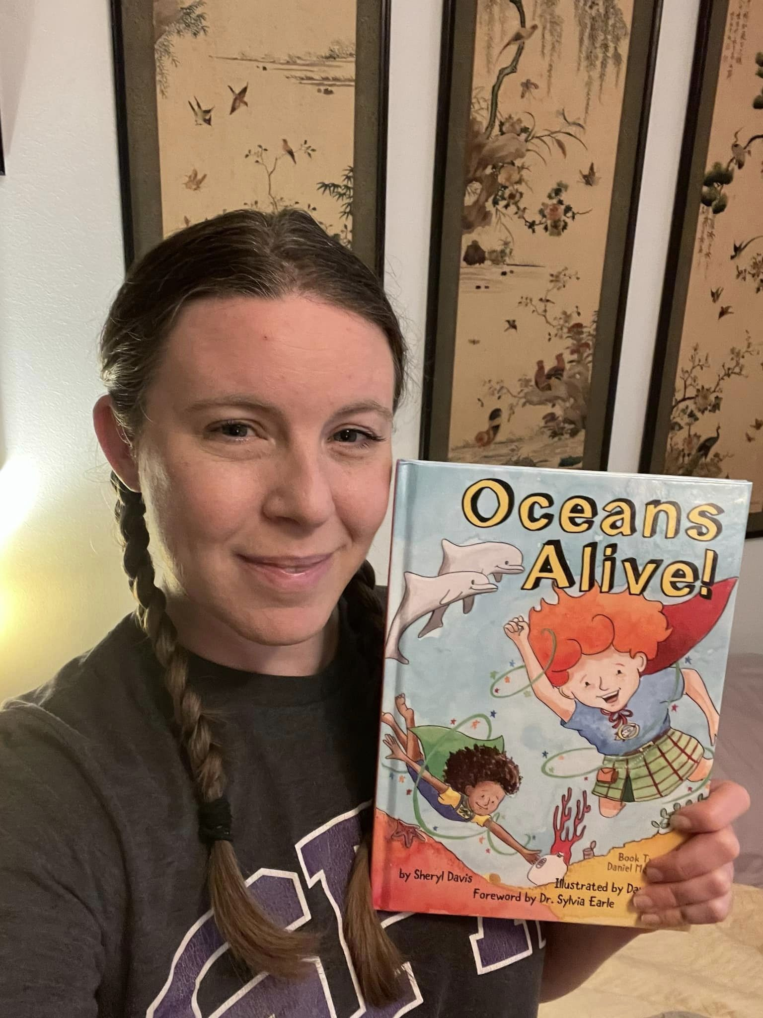 Photo of author Sheryl Davis with her new children's book, "Oceans Alive!"